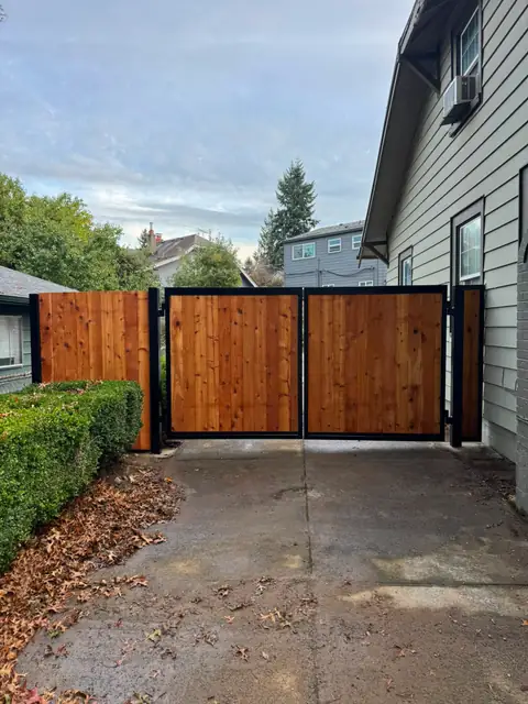 Cedar double swing driveway gate with matching fence panel and hedge