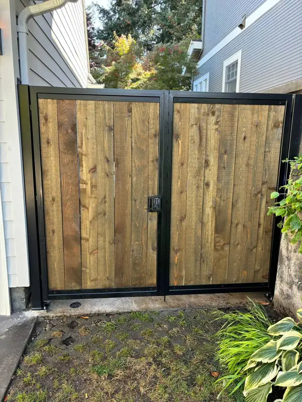 Steel-framed cedar double pedestrian gate with keypad lock in a Portland side yard