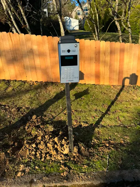 CellGate video intercom keypad on post at cedar fence driveway entry