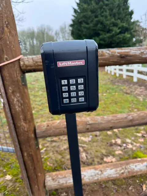 Closeup of LiftMaster wireless keypad mounted on post at country gate
