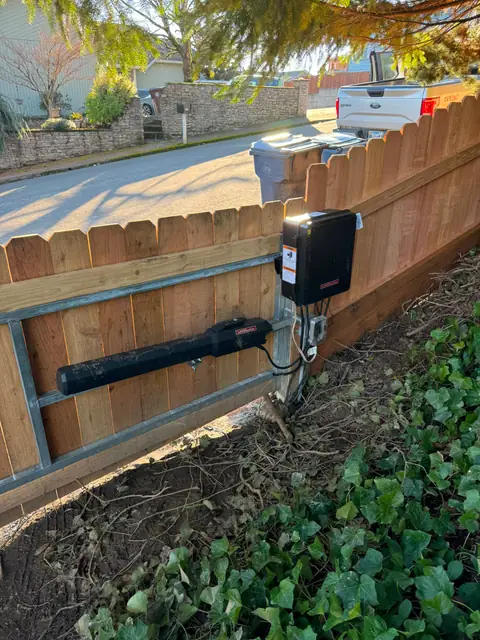 LiftMaster linear gate operator and control box mounted on cedar fence gate