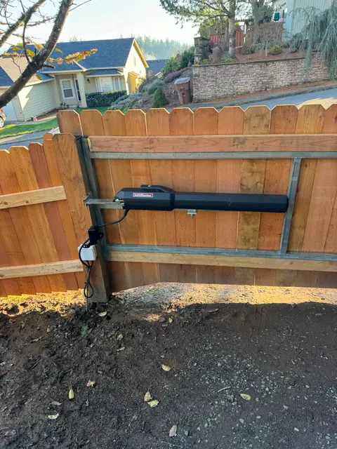 LiftMaster linear ram operator mounted on framed cedar driveway gate